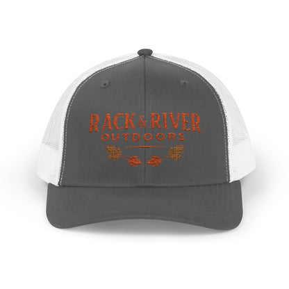 Christian outdoor trucker hat in gray and white with embroidered Rack & River Outdoors logo.”
“Rack & River Outdoors brown trucker cap with orange embroidered outdoor lifestyle logo.