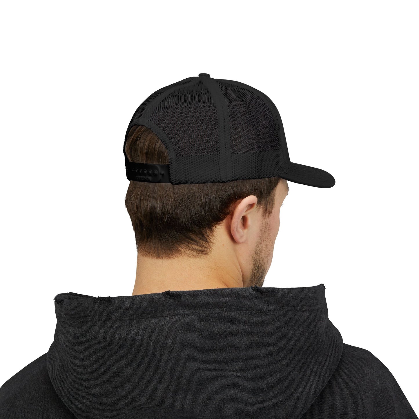 Back view of black Rack & River Outdoors mesh trucker cap on model in black hoodie.