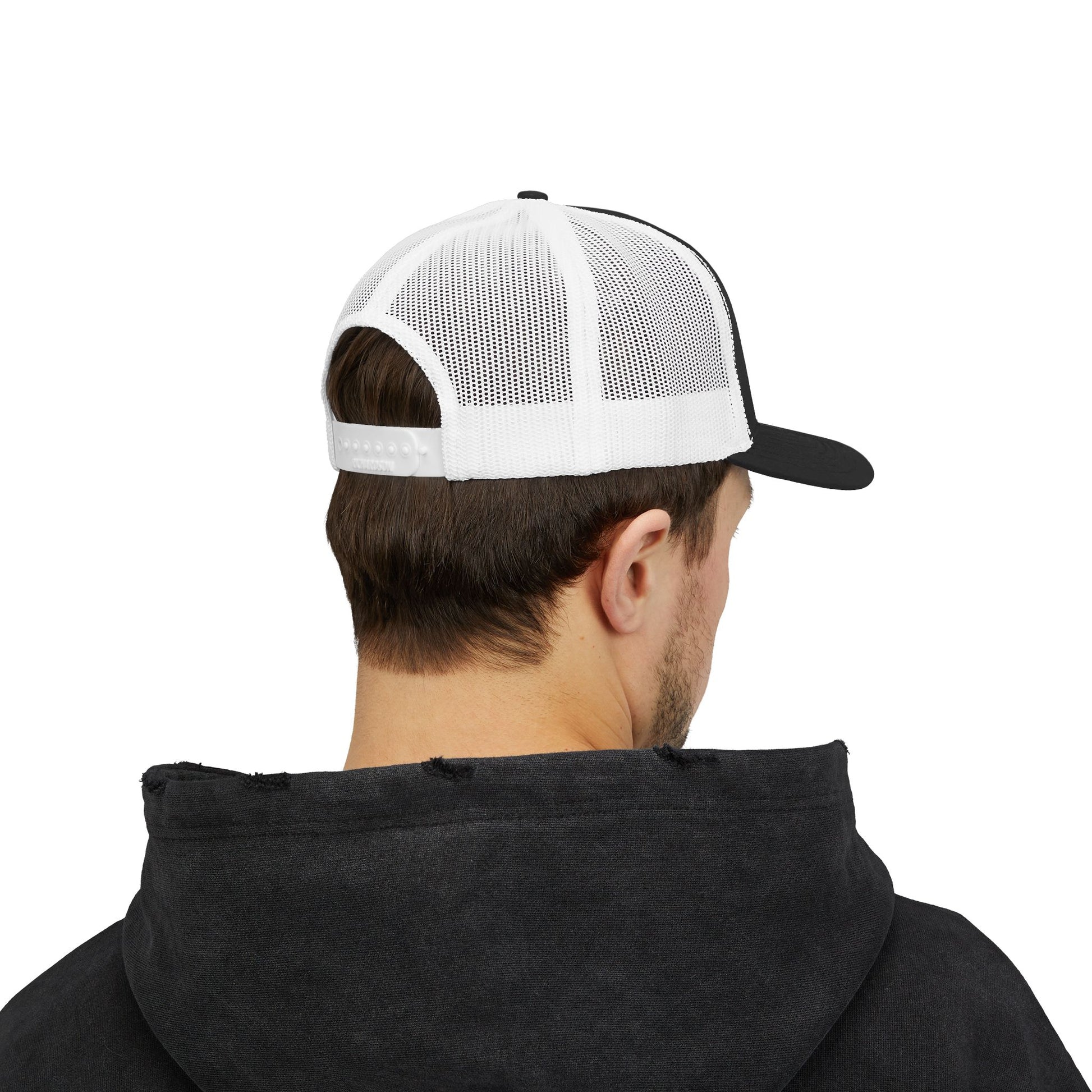 Back view of black and white Rack & River Outdoors mesh trucker cap on model in black hoodie.