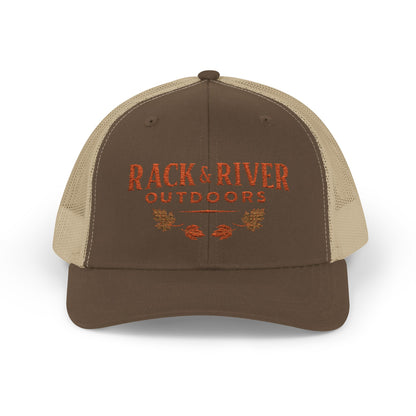 Christian outdoor trucker hat in brown and tan with embroidered Rack & River Outdoors logo.”
“Rack & River Outdoors brown trucker cap with orange embroidered outdoor lifestyle logo.