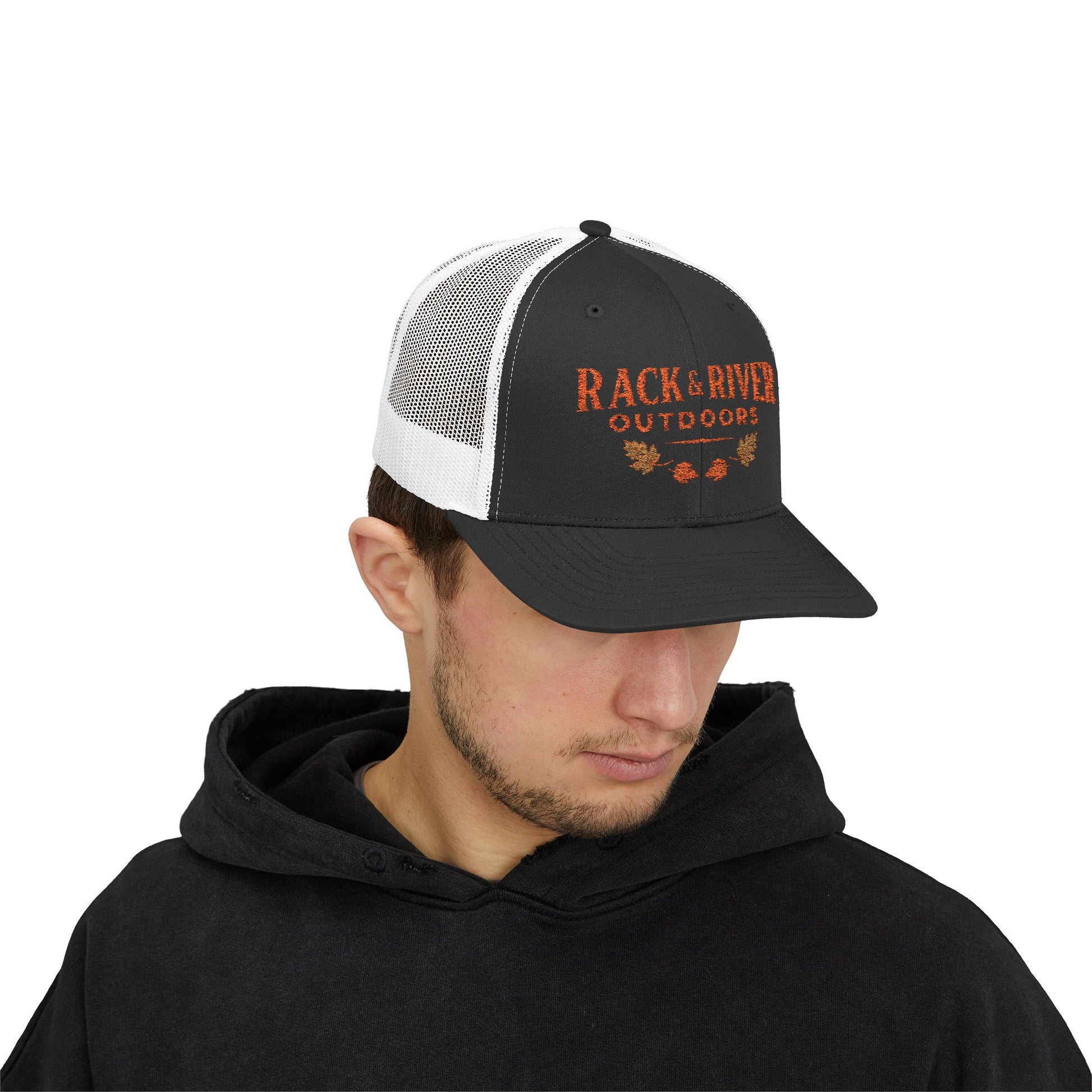Male model in gray and white Rack & River Outdoors trucker cap with orange embroidered outdoor logo.
