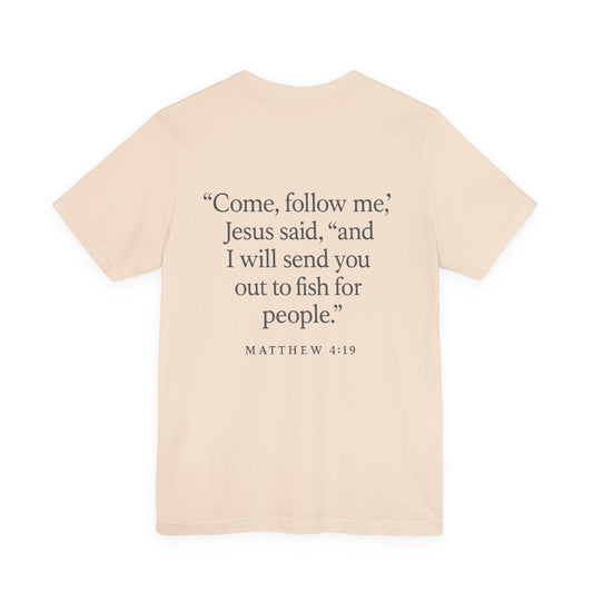 Sand color Christian t-shirt with Matthew 4:19 ‘Come, follow me… I will send you out to fish for people’ back design by Rack & River Outdoors.