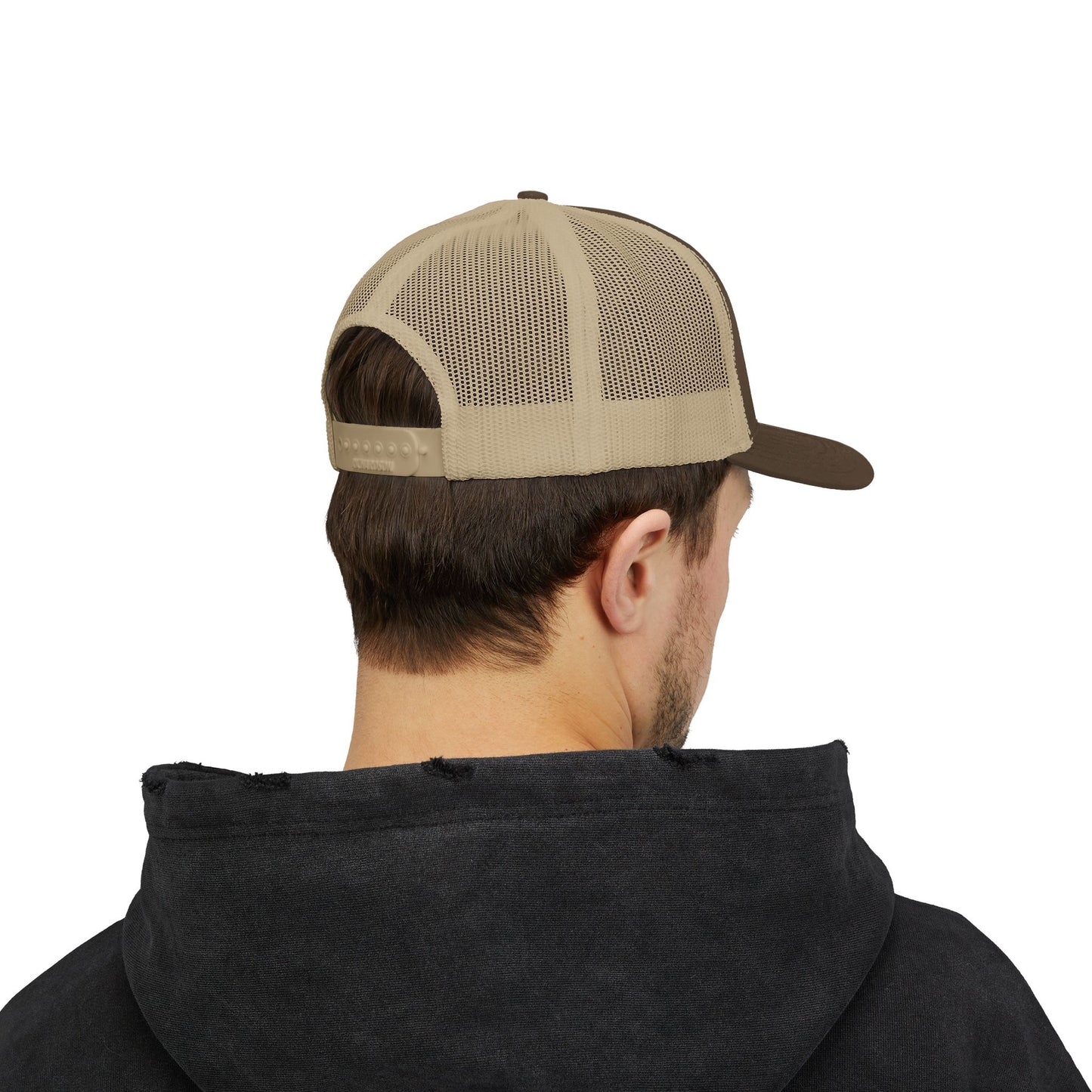 Back view of tan and brown Rack & River Outdoors mesh trucker cap on model in black hoodie.