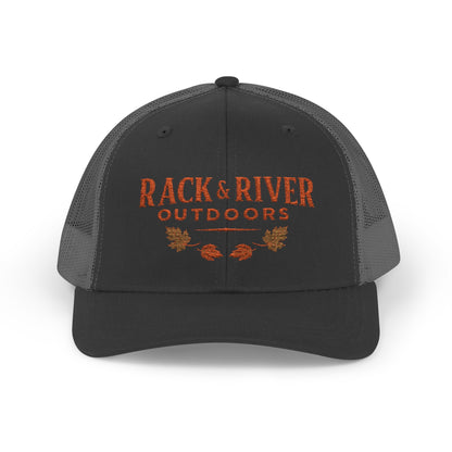 Christian outdoor trucker hat in gray and gray with embroidered Rack & River Outdoors logo.”
“Rack & River Outdoors brown trucker cap with orange embroidered outdoor lifestyle logo.