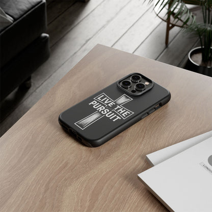 Live The Pursuit Christian phone case displayed on a wooden desk in a modern lifestyle setting.