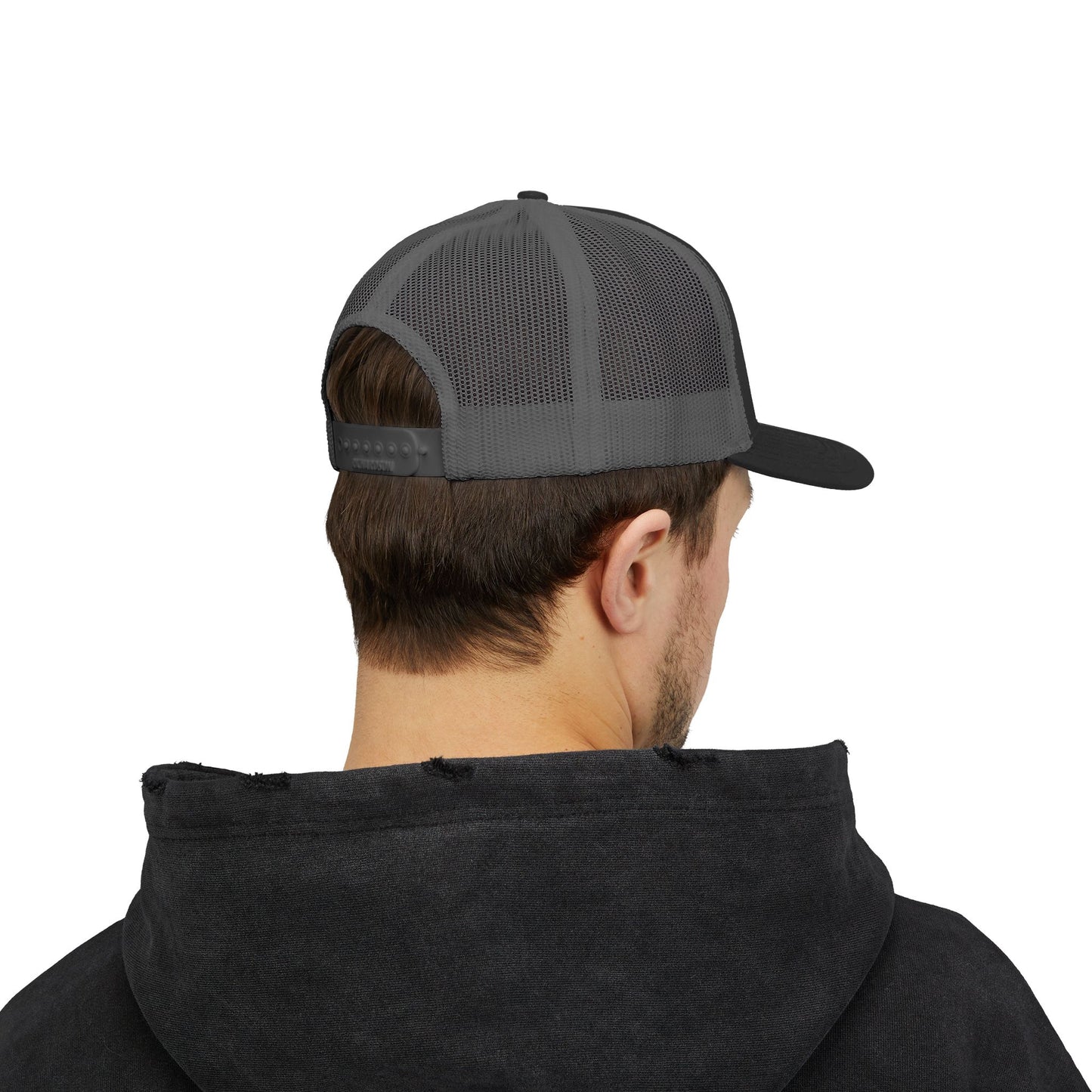 Back view of gray and black Rack & River Outdoors mesh trucker cap on model in black hoodie.