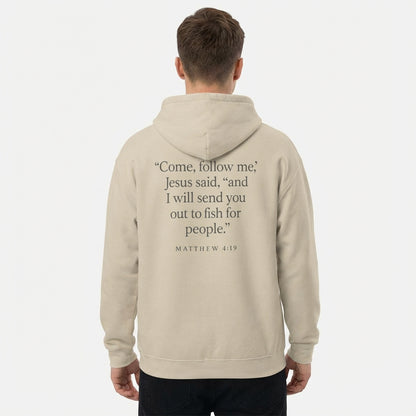 Model wearing sand Matthew 4:19 Christian hoodie with scripture graphic on the back.