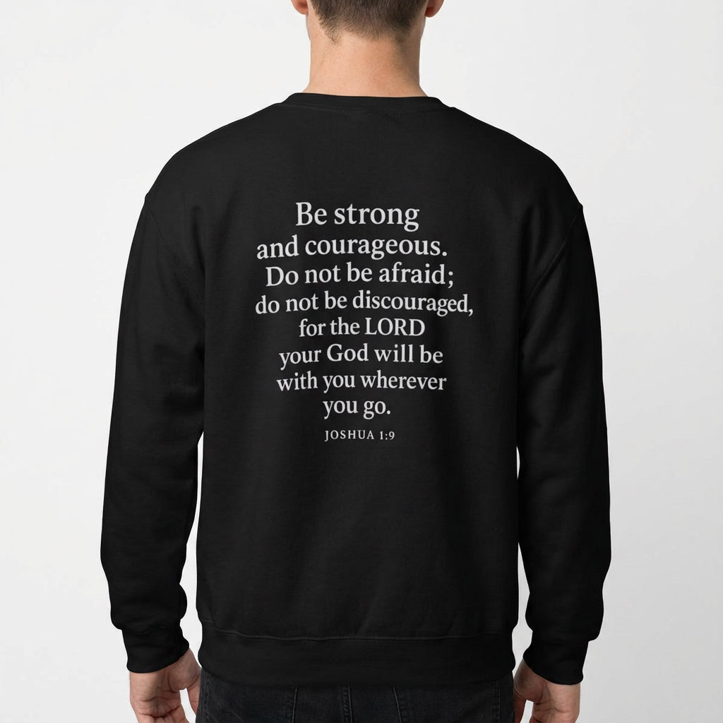 Model wearing black Christian crewneck with Joshua 1:9 scripture design on the back.