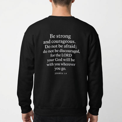 Model wearing black Christian crewneck with Joshua 1:9 scripture design on the back.
